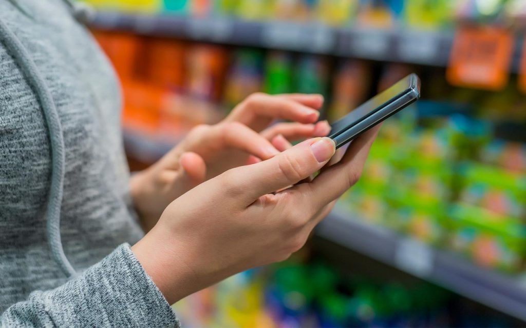 Illustration of consumer checking products online before making a purchase. | Stock Photos